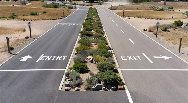Top-down view of campground entry lane design with separate entry and exit lanes