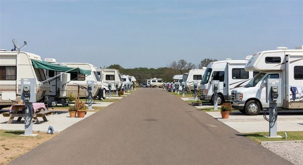 Organized RV park with long-term resident sites showing metered pedestals and resident amenities
